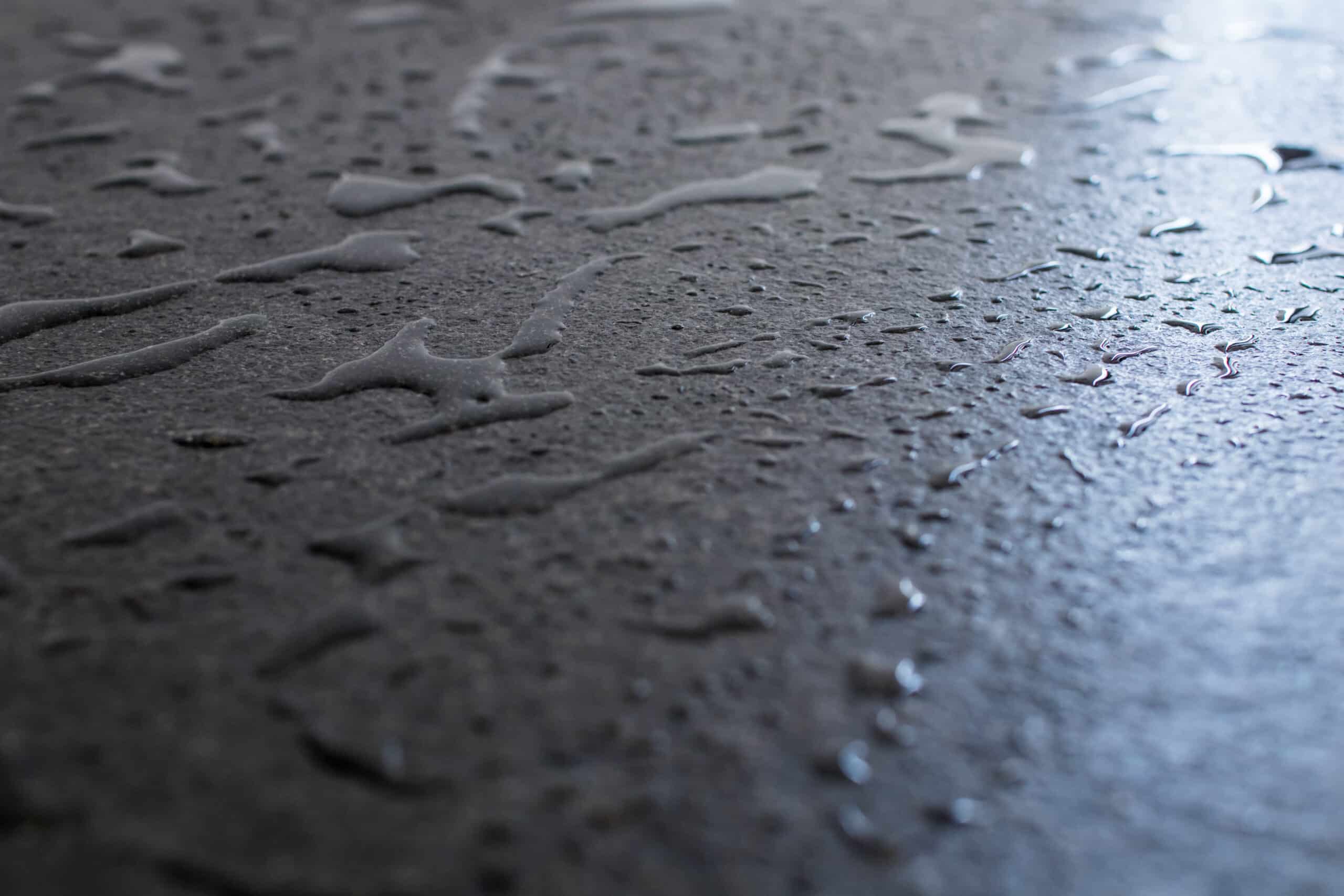 3 Easy Ways To Minimize Garage Floor Sweat Raw and rough black granite slab wet with water. Drops and patch